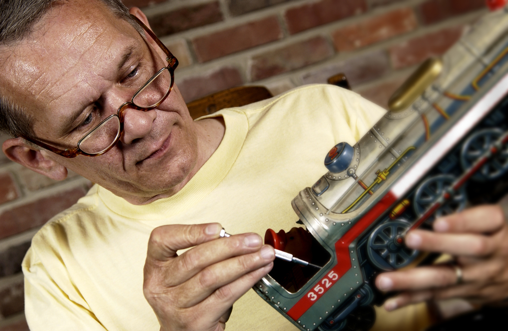 Man Cleaning Model Train