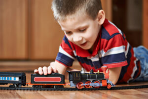 Little Boy playing With Model Railroad